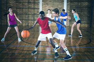 Teenage Boys And Girls Indoor Basketball Game